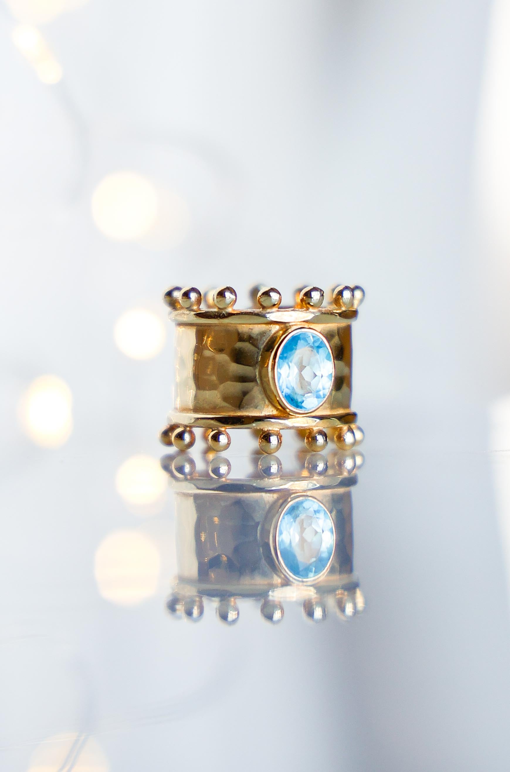 ANILLO ETER GOLD Y SWISS TOPACIO CELESTE